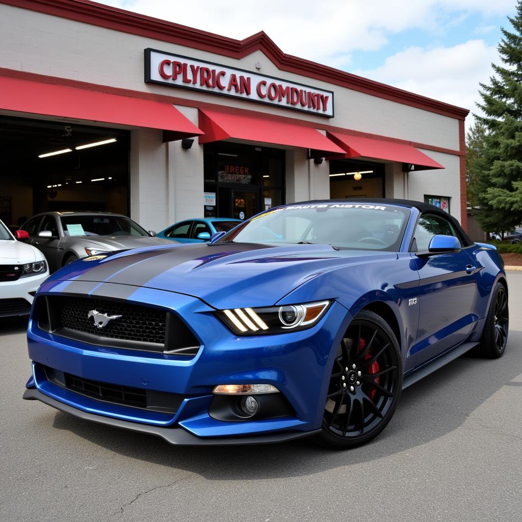 Ein Ford Mustang steht vor einer Autowerkstatt.